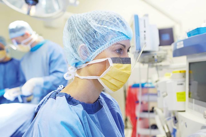 Woman in OR on monitors