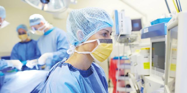 Woman in OR on monitors