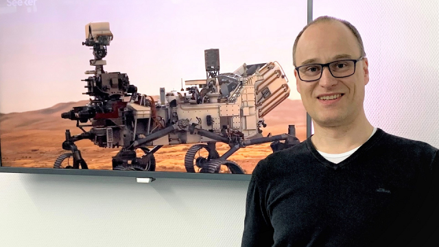 Sales manager of the company SmartGAS with a gas sensor in his hand Micro-hybrid IR emitter on Mars mission