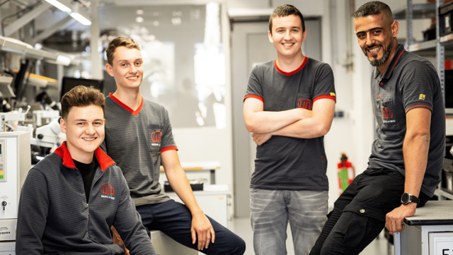 Gruppenbild von 4 Auszubildenden in der Fertigung bei der Micro-Hybrid am Standort Hermsdorf