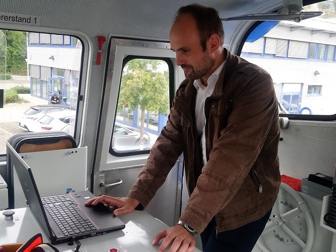 Micro-Hybrid Account Manager Maximilian Eckardt stands in a train and tests railway sensors