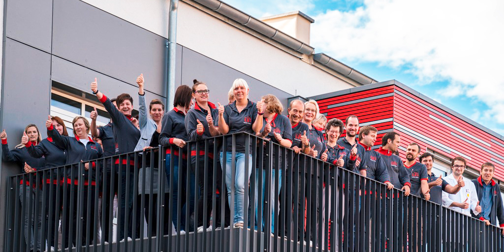 Group picture of the Micro-Hybrid employees on the balcony
